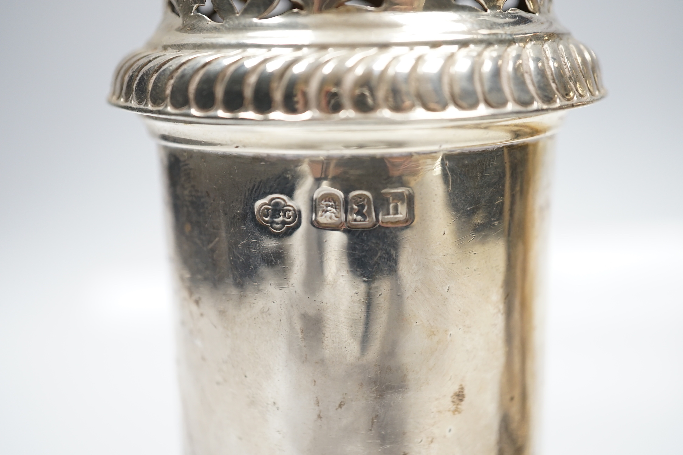 A matched pair of Britannia standard silver lighthouse sugar casters, Carrington & Co, London, 1903 and Wilson & Gill, London, 1963, 20.8cm, 22.6oz.
